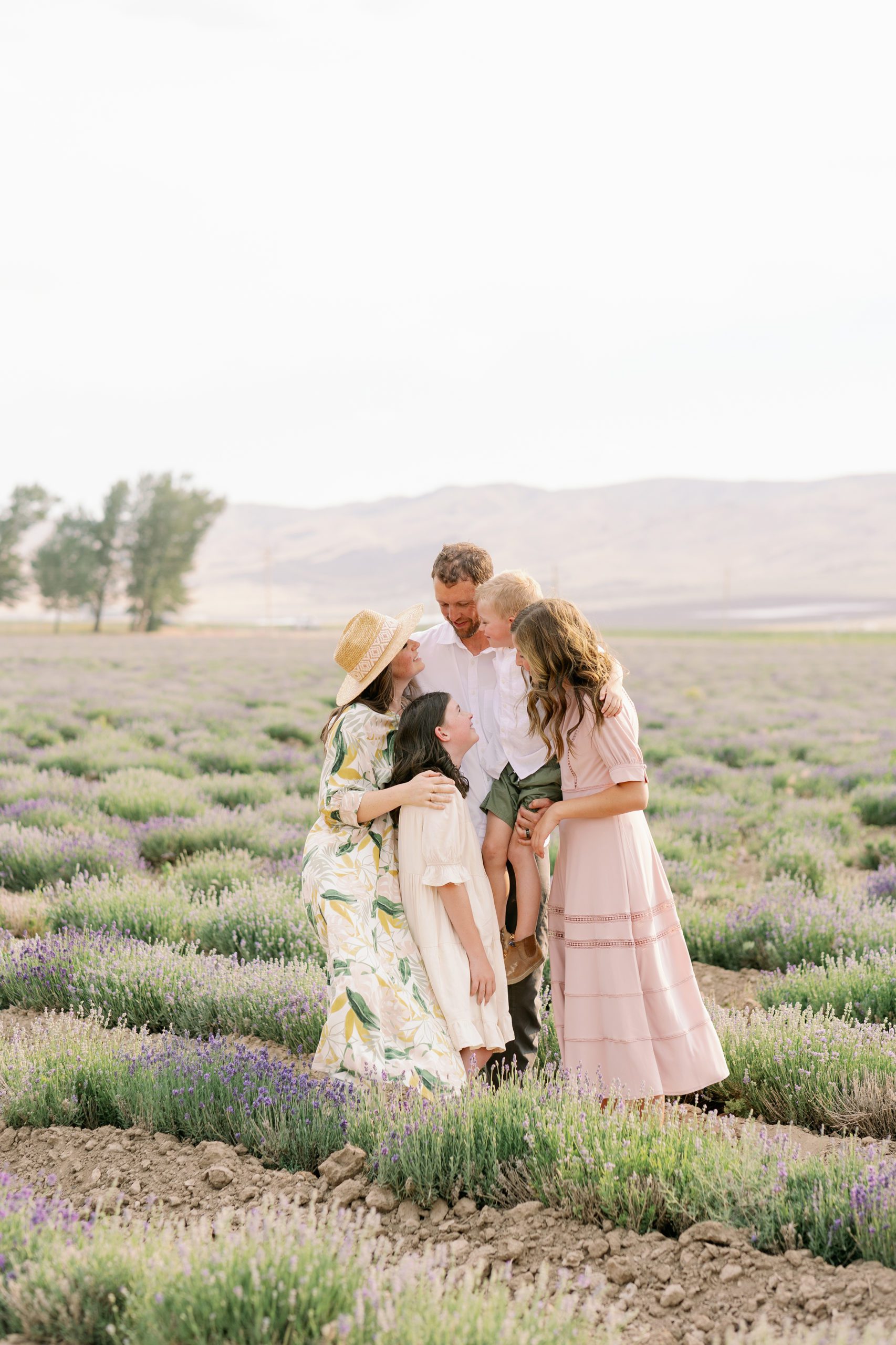 Family hugging in a lavender field